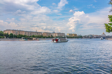 Cruise ship sails on the Moscow river in Moscow city center, popular place for walking.