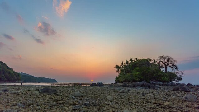 .timelapse scenery sunset in the channel between Koh Pling and Naiyang beach .Phuket Thailand.during low tide tourists can walk to the small island..colorful sky texture, abstract nature background..