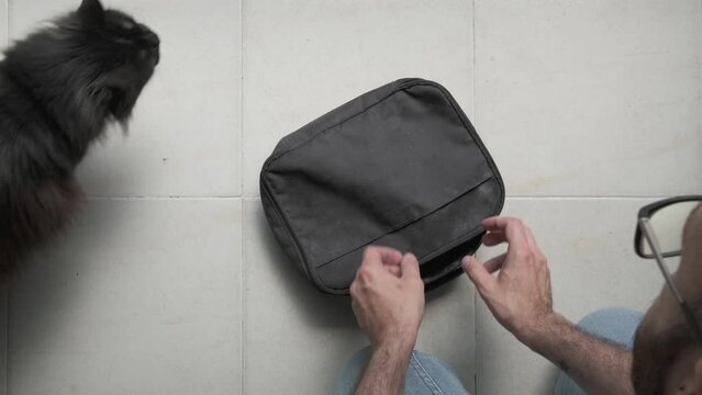 person hand opening job bag to take a battery powered electric machine to work

