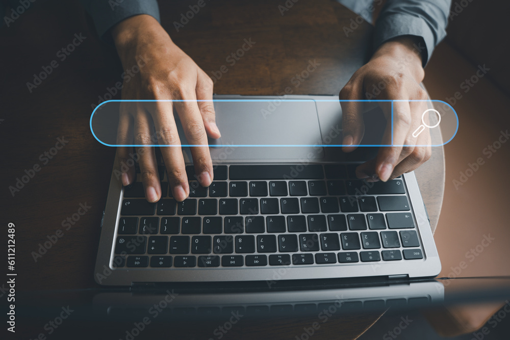Poster businessman's hand typing on laptop, searching and browsing the internet for information using a bla