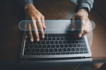 Businessman's hand typing on laptop, searching and browsing the internet for information using a...