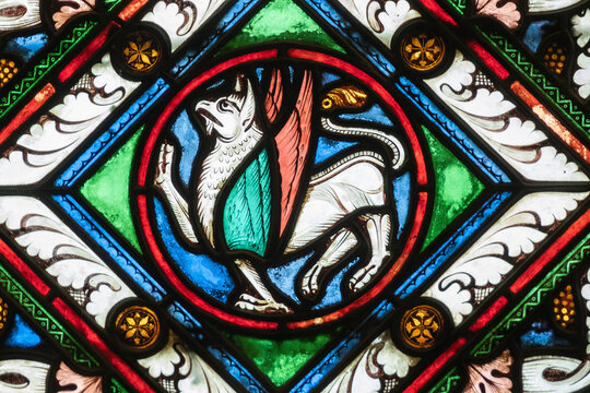 Stained glass detail of an early medieval mythical creature, a winged griffin in St. Denis Basilica Paris, France