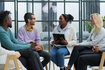 Business executive delivering a presentation to his colleagues during meeting or in-house workshop.