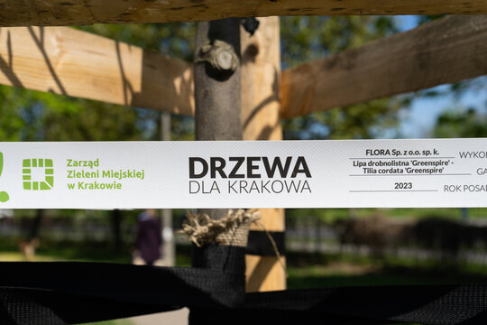 Municipal Greenery Authority in Krak&oacute;w logo sign. Tape on a newly planted tree, as part of the ecological program Trees For Cracow by ZZM Zarząd Zieleni Miejskiej on May 1, 2022 in Krakow, Poland.
