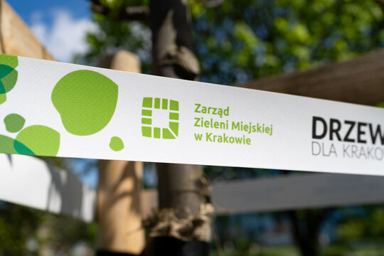 Municipal Greenery Authority in Krak&oacute;w logo sign. Tape on a newly planted tree, as part of the ecological program Trees For Cracow by ZZM Zarząd Zieleni Miejskiej on May 1, 2022 in Krakow, Poland.