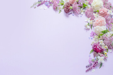 Fototapeta na wymiar beautiful summer flowers on light purple background