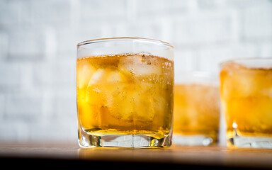 Whiskey with sparkling water and ice on white background