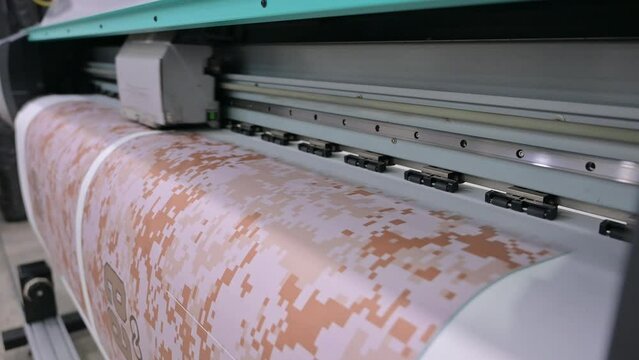 Industrial sublimation printer for digital printing on fabrics. Modern textile industry. Textile printing is the process of applying colour to fabric in definite patterns or designs.