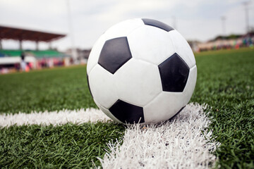 Fototapeta na wymiar soccer ball on green grass and line