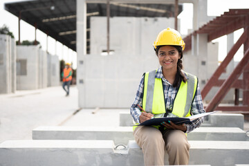 India engineer woman working with document at precast site work	