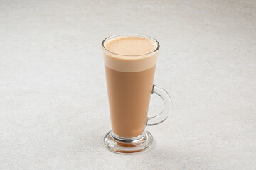 Glass mug of hot latte coffee macchiato