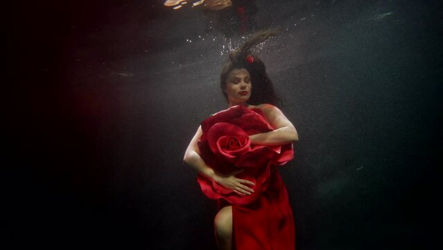 amazing female beauty and femininity, underwater shot with attractive brunette woman