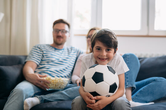 Happy Boy Is Excited To Watch Soccer Game With His Parents.