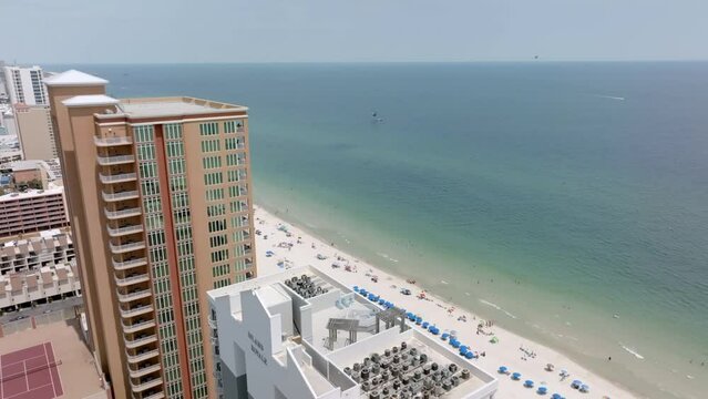 Gulf Shores, Alabama skyline and beach with drone video moving in close to hotel.