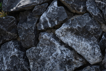 Texture of gray stones with white inserts.