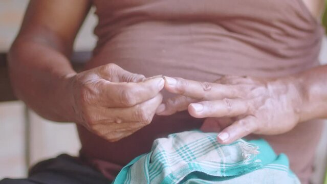 Man cleaning his fingernails with blade front view