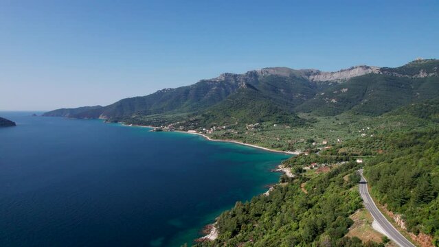 Drone View Over Kinira View Point With High Mountain Peaks, Lush Green Vegetation, Mountain Road And Tropical Beaches In The Distance, Thassos Island, Greece