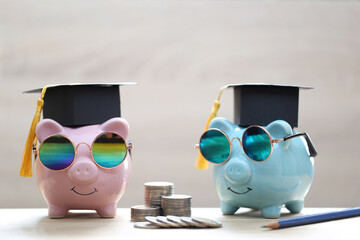 Graduation hat on piggy bank and stack of coins money on white background, Saving money for...