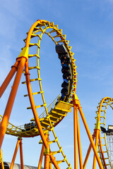 roller coaster ride on a sunny day blue sky