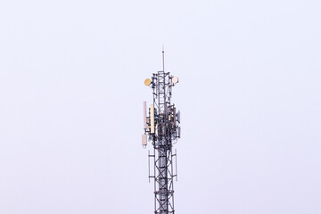 Telecommunication tower. Wireless Communication Antenna Transmitter with antennas bright sunlight and sky background. tower 4G, 5G cellular Base Station or Base Transceiver Station future technology.