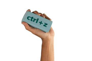 black male Hand holding an eraser with inscription ctrl z on white background
