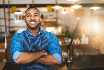 Obraz premium Coffee shop, barista and portrait of happy black man in restaurant for service, working and crossed arms. Small business owner, bistro and professional male waiter smile in cafeteria ready to serve
