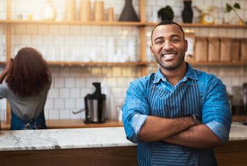Cafe, crossed arms and portrait of black man barista for service, working and coffee shop startup. Small business owner, restaurant and professional male waiter smile in cafeteria ready to serve