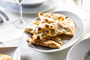 Focaccia flatbread slices with rosemary freshly baked and sliced to triangles