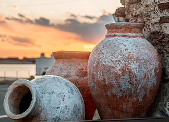 Large terracotta clay pots with sunset sky background