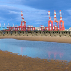 Red cranes with water reflections along the port of Liverpool dock Merseyside