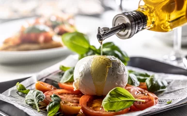 Foto op Canvas Olive oil poured over buffalo mozzarella ball on a differently styled Caprese salad © weyo