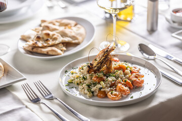 Italian creamy shrimp and zucchini risotto with a decorative shrimp on top
