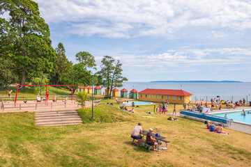 Bathing place with playing children at a playground