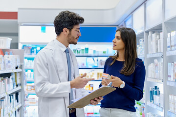 Pharmacy, medicine and pharmacist talking to customer while working in a retail store. Professional man in pharmaceutical or medical industry for service, healthcare and advice for a woman client