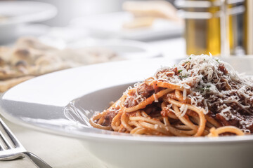 Detail of spaghetti with tomato sauce, basil, and parmesan on top