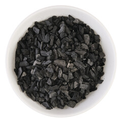 Overhead view of charcoal soaked with styrax balm (benzoin resin) in a white bowl, isolated on...