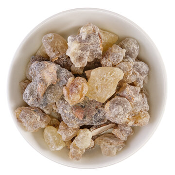 Overhead view of frankincense from Oman (Boswellia sacra), a tree resin, in a white bowl, isolated on background