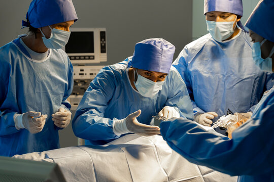 Teamwork of surgeon preparing for surgery in operating room