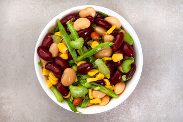fresh bean salad with vinaigrette and sweet corn on grey
