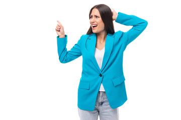 emotional stylish young brunette businesswoman in a blue jacket yells at subordinates on a white background with copy space