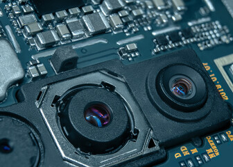 Macro shot of the smartphone's main board with the camera unit in the foreground