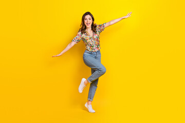 Fototapeta na wymiar Full length photo of excited cute lady wear retro flower print blouse arms sides having fun isolated yellow color background