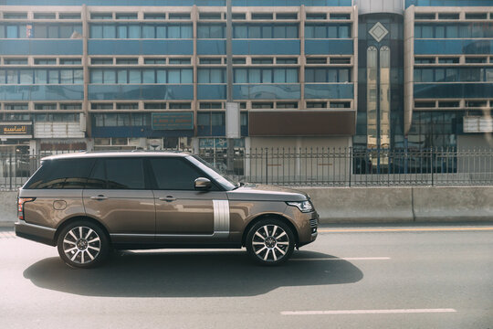 Dubai, UAE, United Arab Emirates - May 28, 2021: Black 2013 Range Rover Vogue car fast mooving on street in Dubai. Land Rover Range Rover Voque is series of subcompact luxury crossover SUVs produced