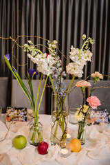 Luxury elegant table setting dinner in a restaurant. Selective focus. Preparation, decorating of banquet table for a birthday party. Wedding reception. Decor of flowers, greenery and candles. Closeup.