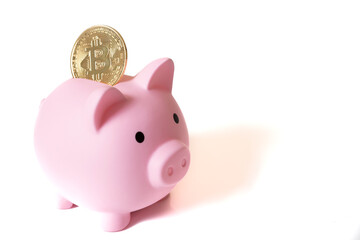 metal bitcoin coin and pink piggy bank on white background with space for text