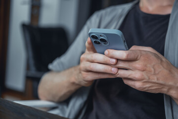 Young man using smartphone in hand, cafe, office,outdoor portrait business man, hipster style, internet, smartphone, office, Bali Indonesia, holding, mac OS, manager, freelancer, concept
