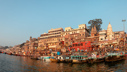 Fototapeta na wymiar Panorama of the city of Varanasi at dawn. View of Varanasi ghats and boats