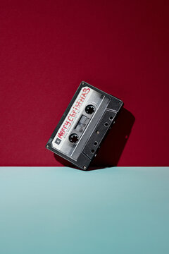 Old-fashioned cassette against burgundy background