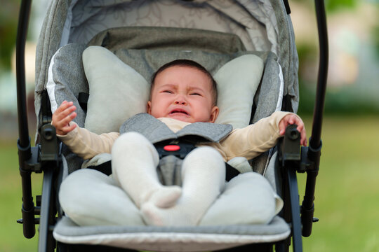 infant baby crying while sitting in stroller