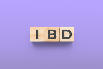 IBD (Inflammatory Bowel Disease) wooden cubes on purple background